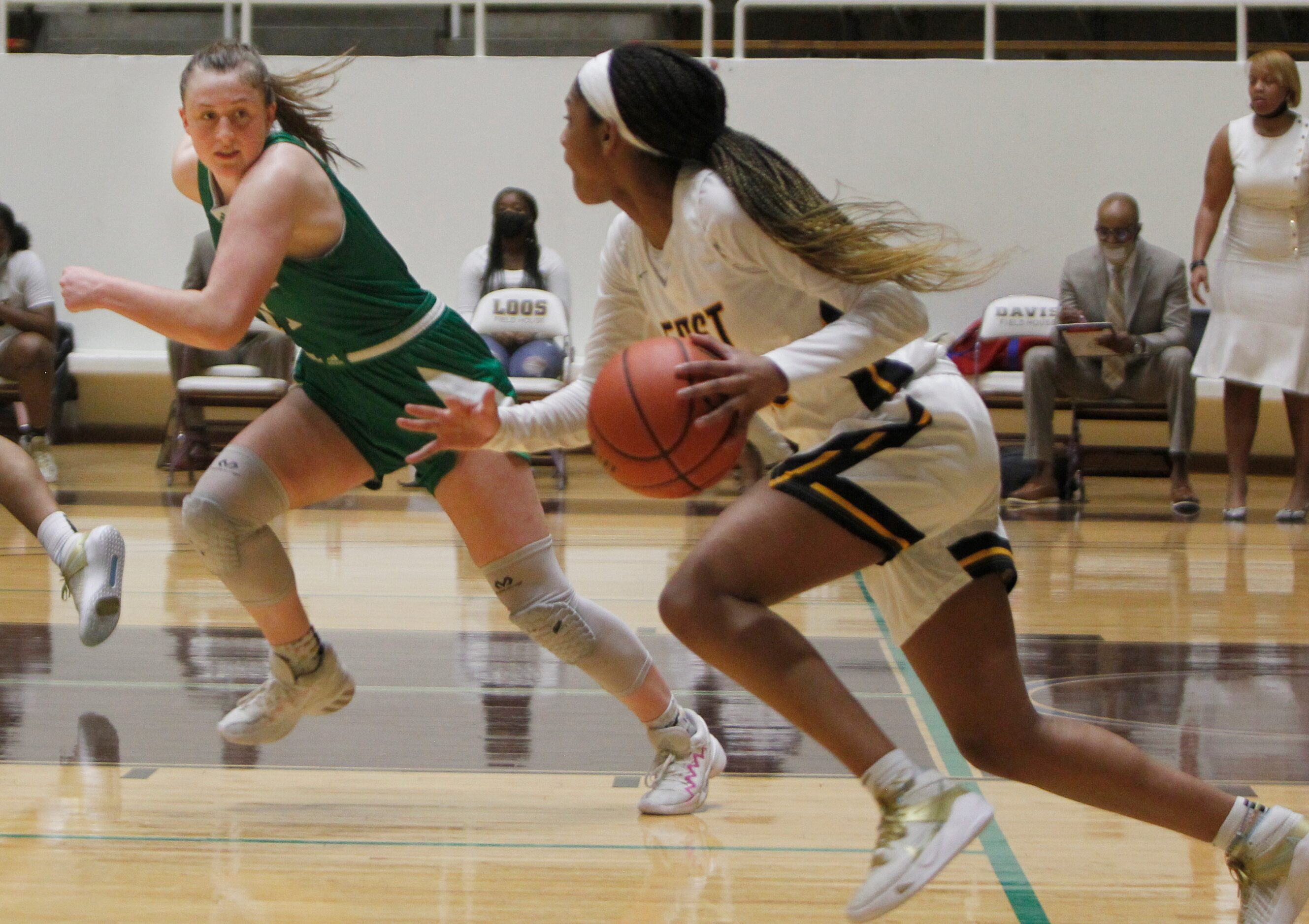 Southlake Carroll guard Kaelyn Riley (11) , left, stays in step with Plano East guard Kayla...