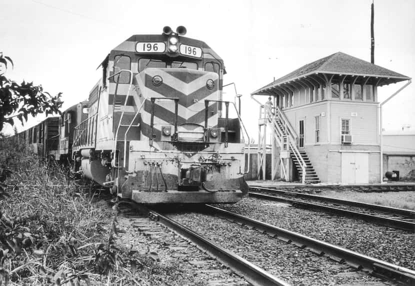 ORG XMIT:  A Katy freight train passes a railroad tower in 1975.