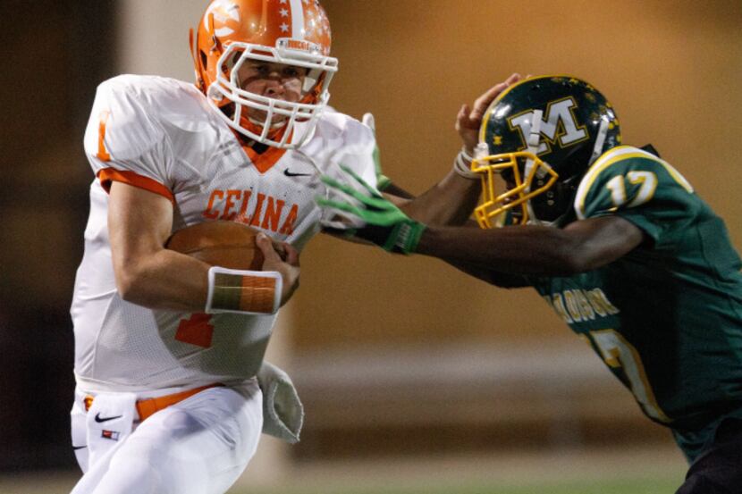 Celina's quarterback, Nathan Elliott (1) breaks a Madison tackle during the Class 3A...