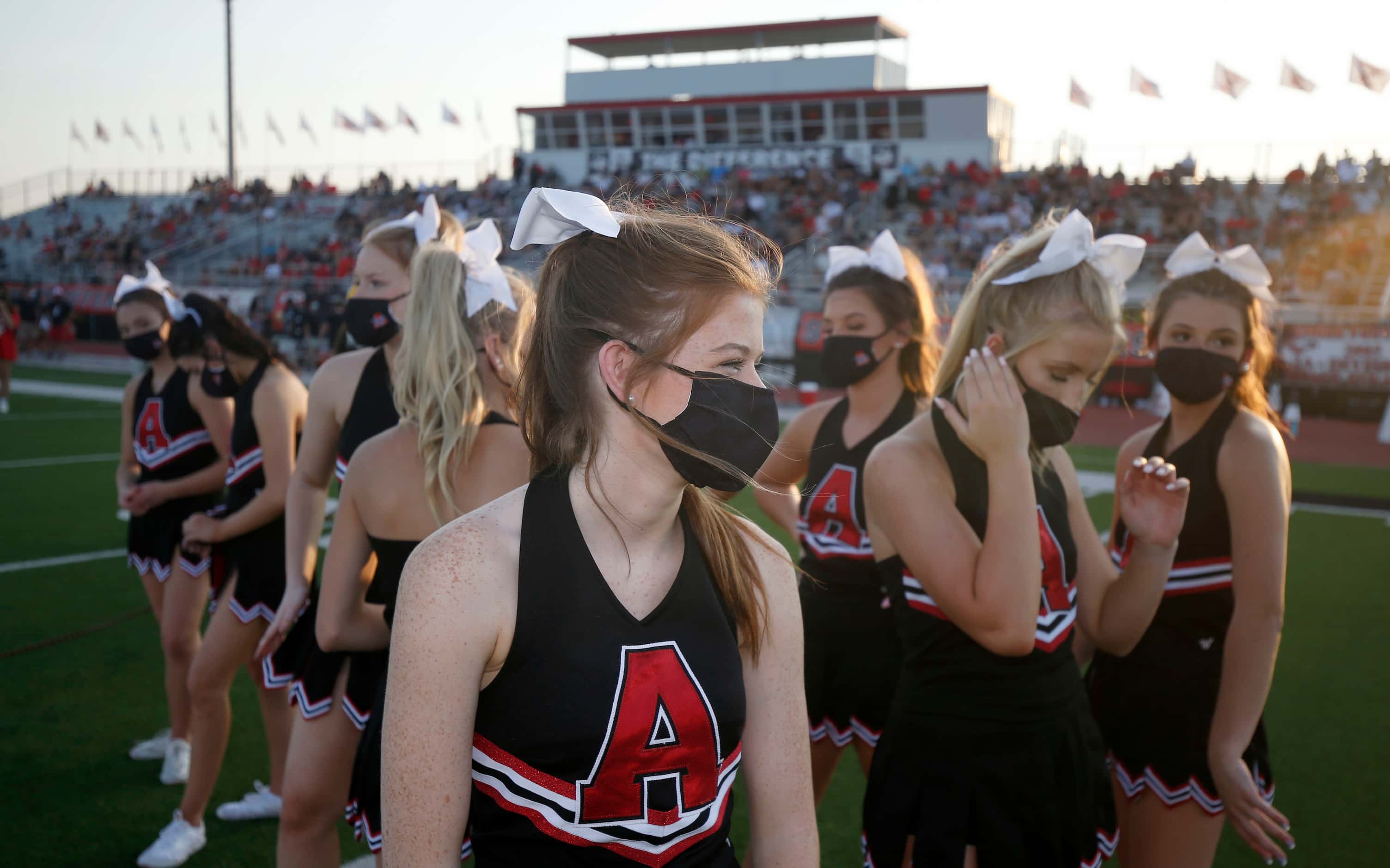 Argyle cheerleaders prepare for pre-game rituals during a high school football game in...