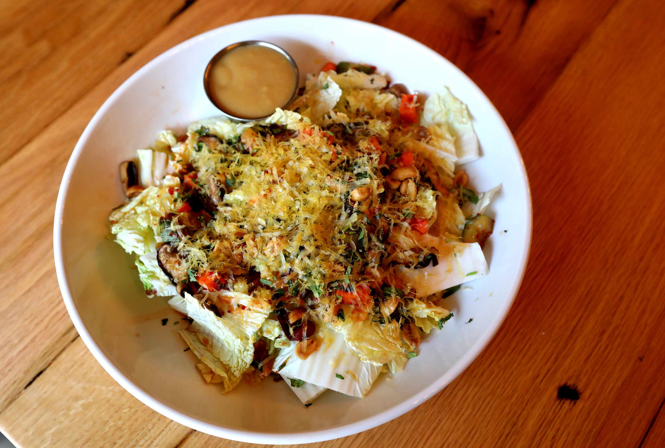 The Napa cabbage salad with Miso ginger vinaigrette with pickled Shiitake, cucumber Kimchi,...