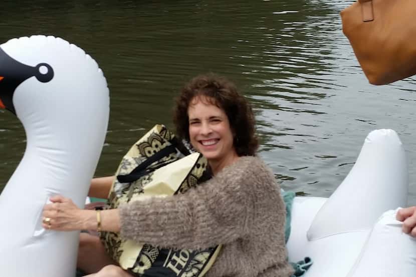  Cathy Allen Rude, a midwife, rides an inflatable swan to assist in a birth in Houston....