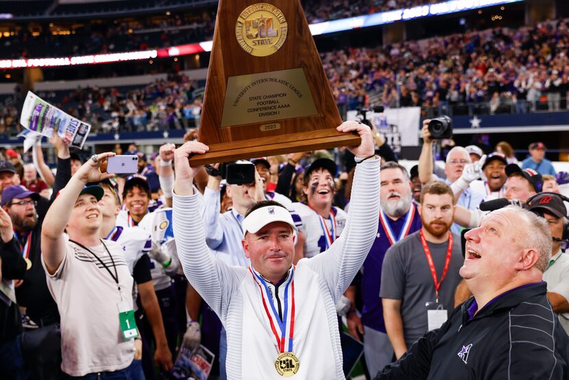 Anna high head coach Seth Parr lifts the trophy following their victory against Tyler Chapel...