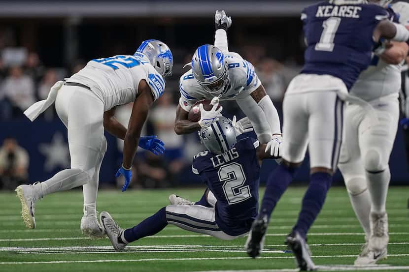 Detroit Lions wide receiver Jameson Williams (9) is upended by Dallas Cowboys cornerback...