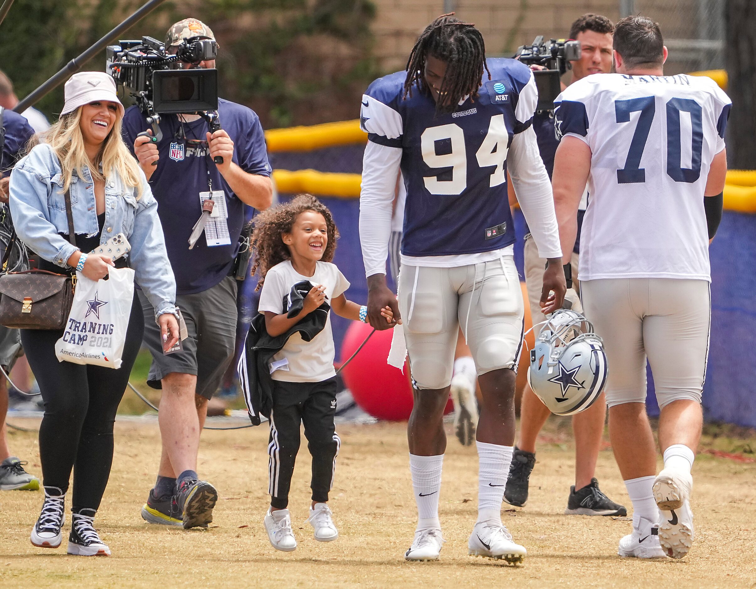 Dallas Cowboys defensive end Randy Gregory (94) holds hands with his daughter Sophia as he...