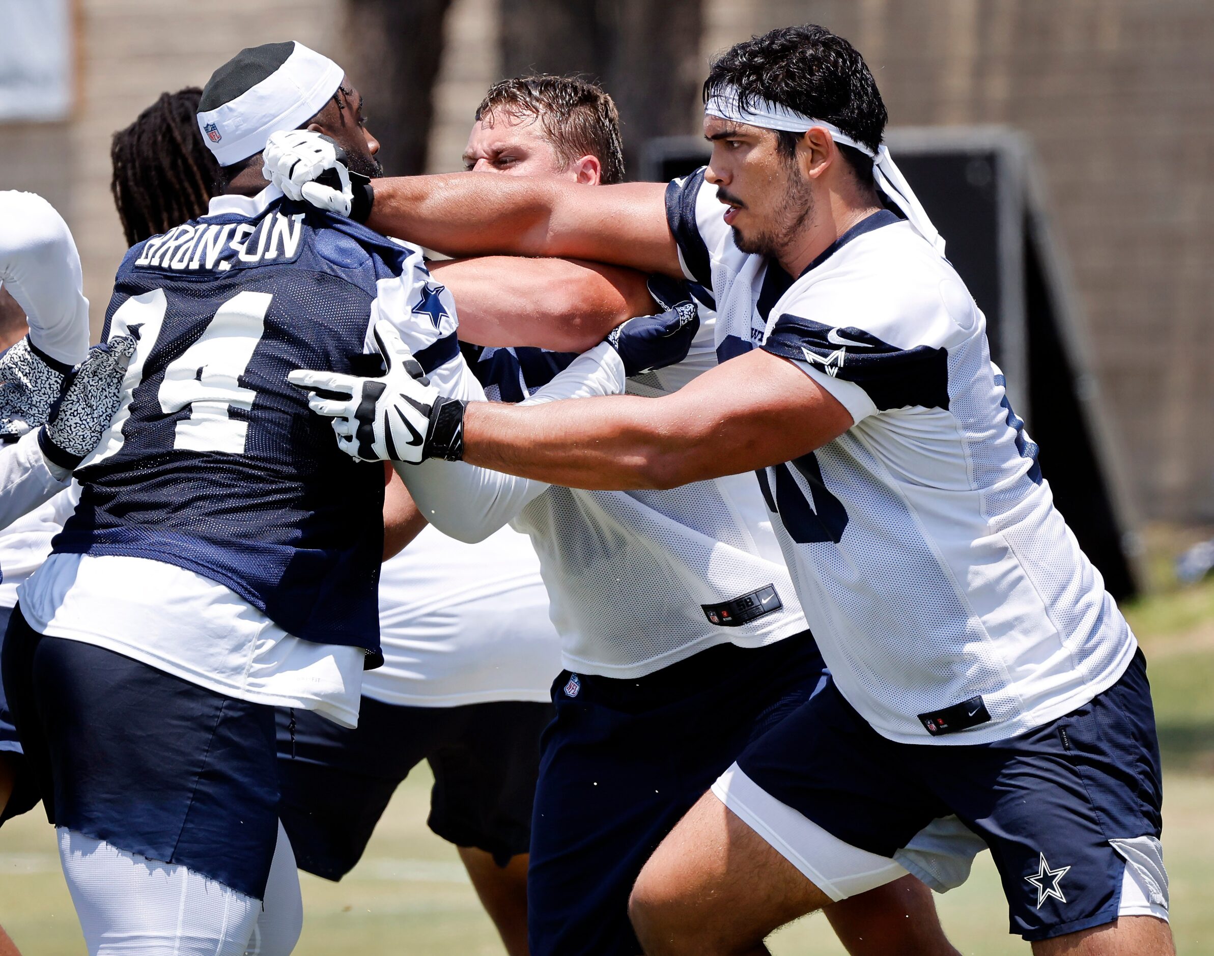 Dallas Cowboys offensive tackle Isaac Alarcon (60) fends off defensive tackle Josiah Bronson...