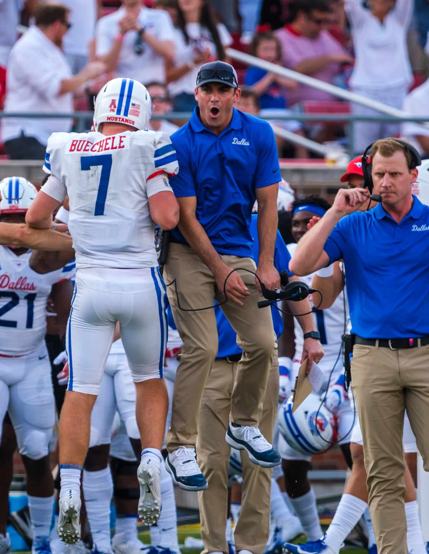 SMU quarterback Shane Buechele (7) celebrates with coaches after a touchdown during the...