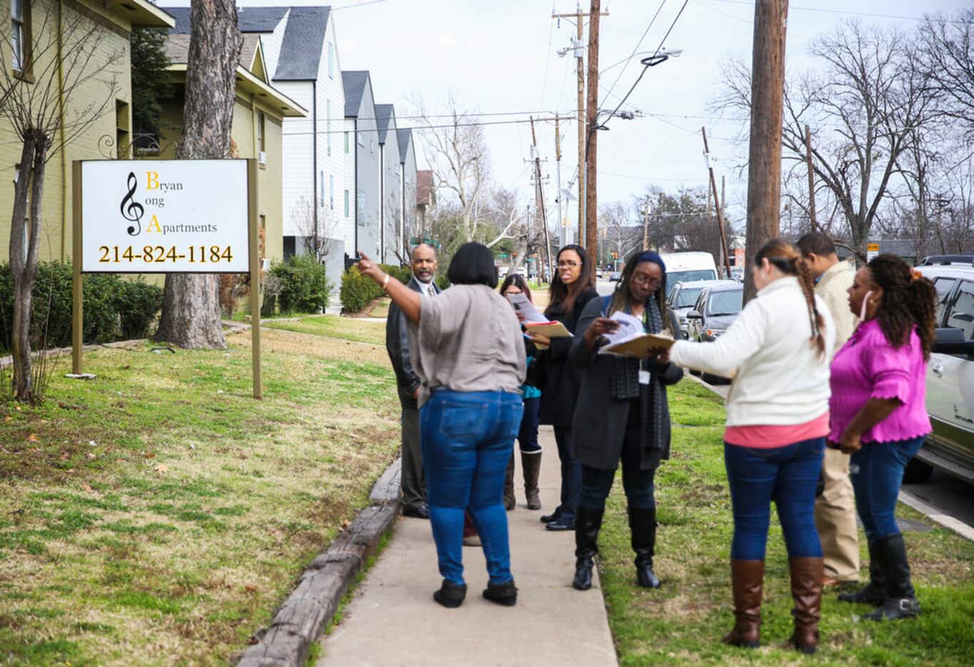 Workers from the city's Fair Housing Department gathered in front of Bryan Song Apartments...