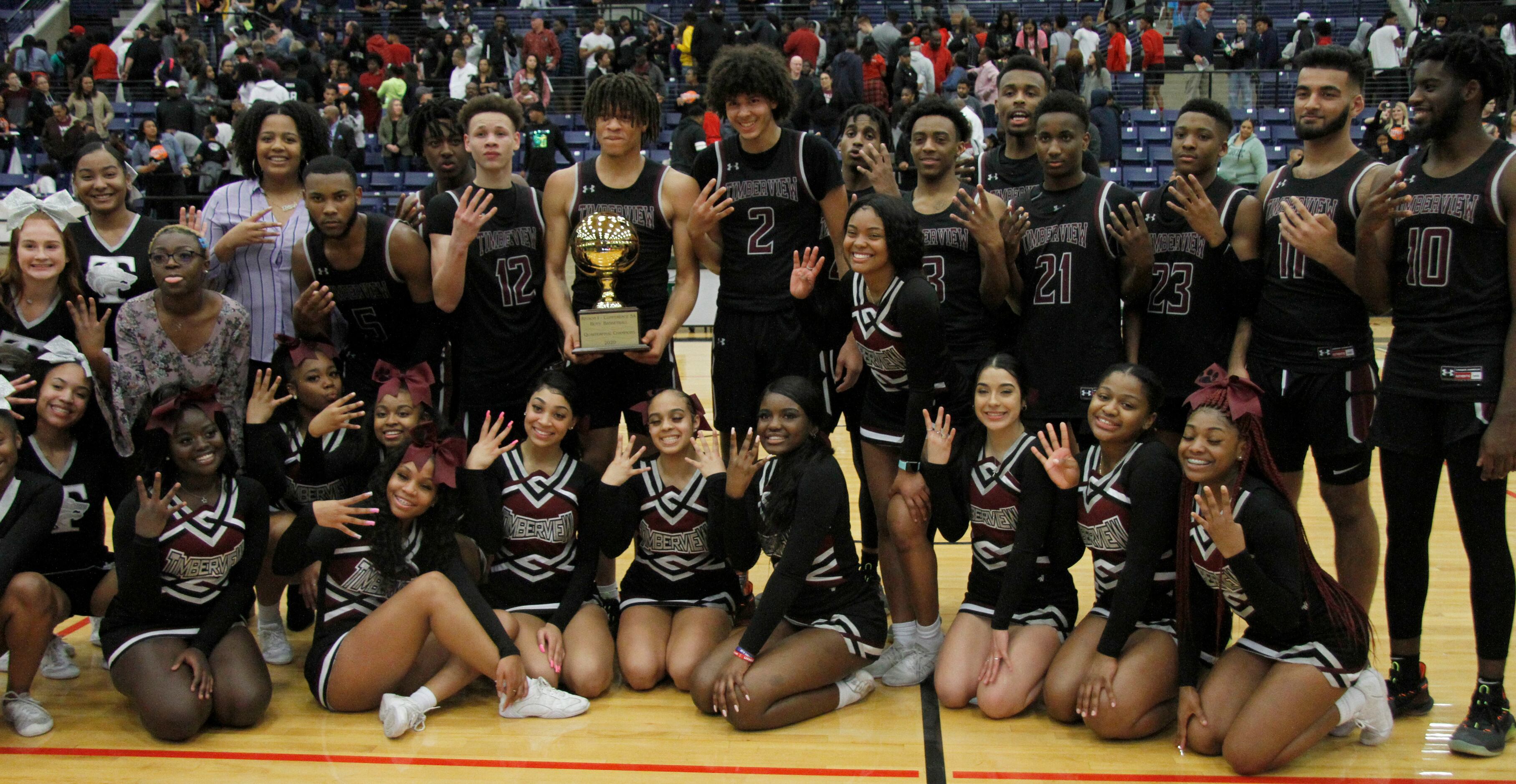 Members of the Mansfield Timberview varsity boys basketball team pose with Wolves...