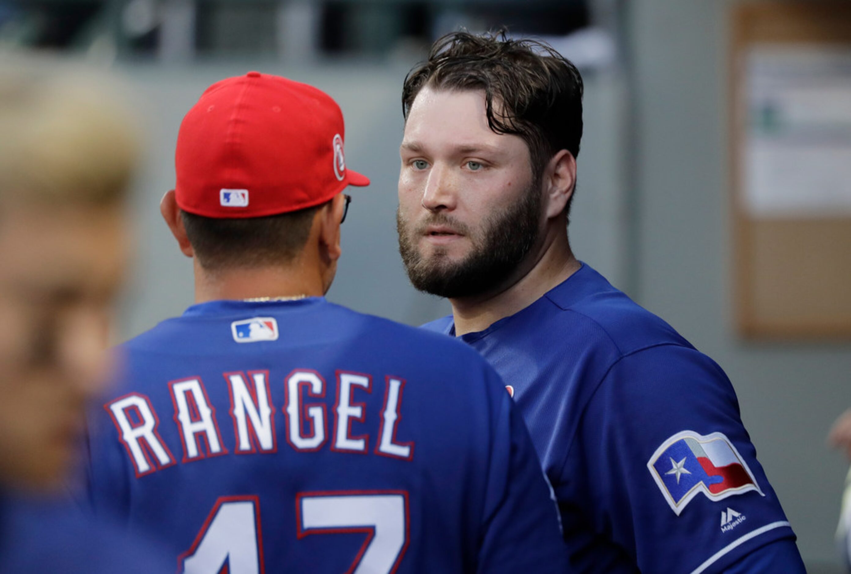 Texas Rangers starting pitcher Lance Lynn, right, talks with pitching coach Julio Rangel...