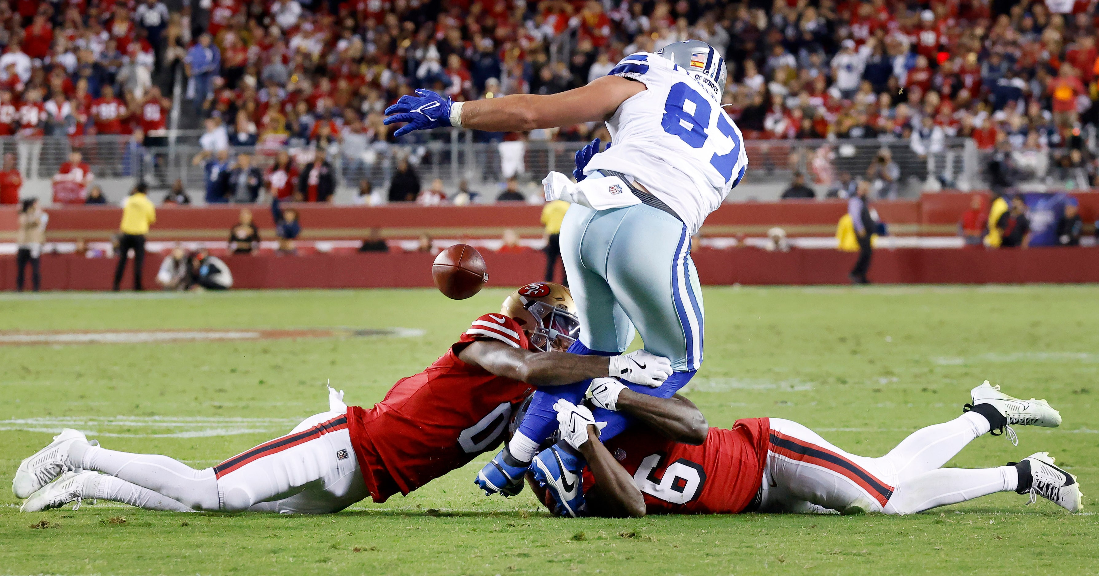 Dallas Cowboys tight end Jake Ferguson (87) looses the ball as he’s hit by San Francisco...