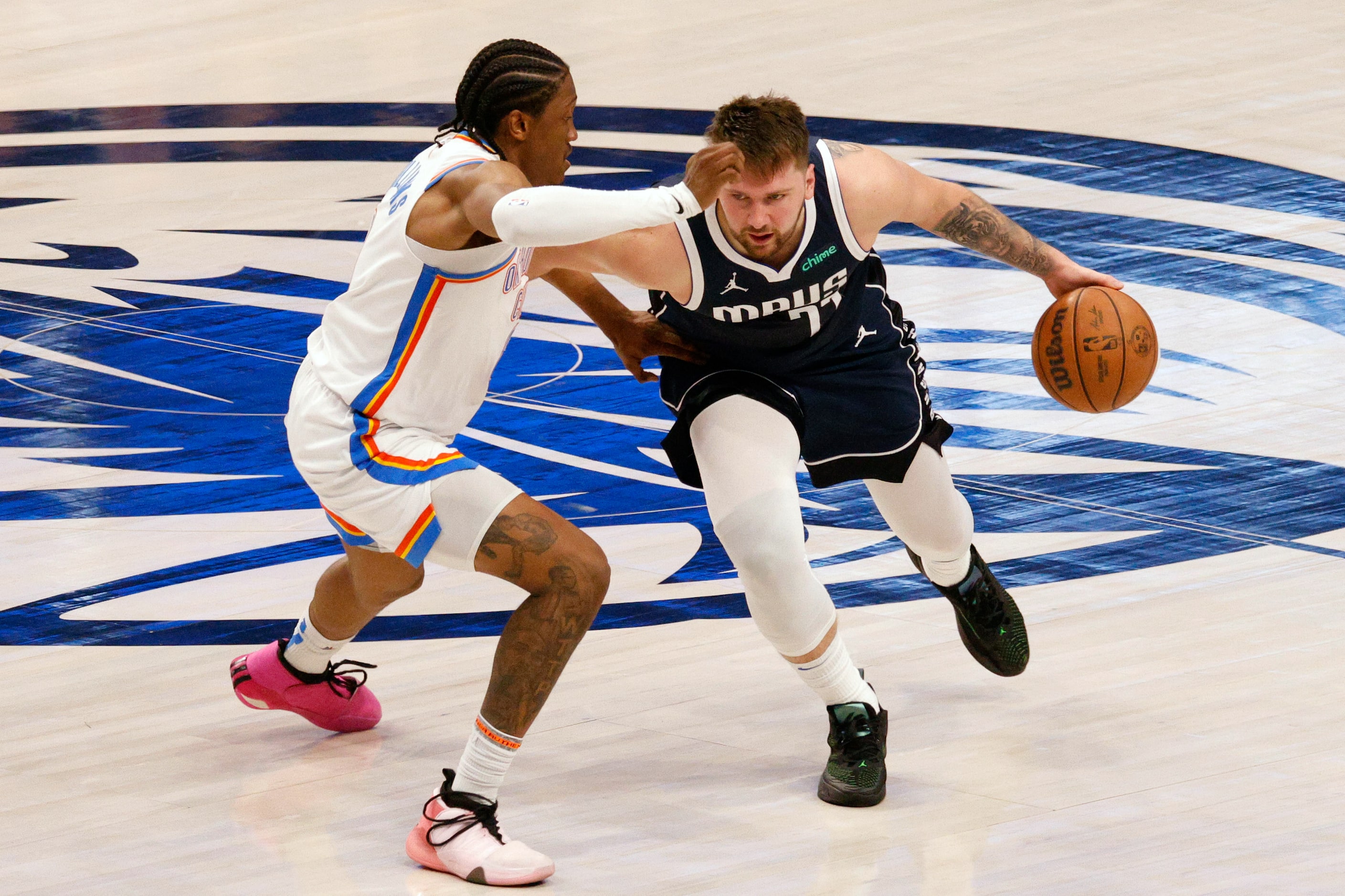 Dallas Mavericks guard Luka Doncic (77) tries to drive past Oklahoma City Thunder forward...