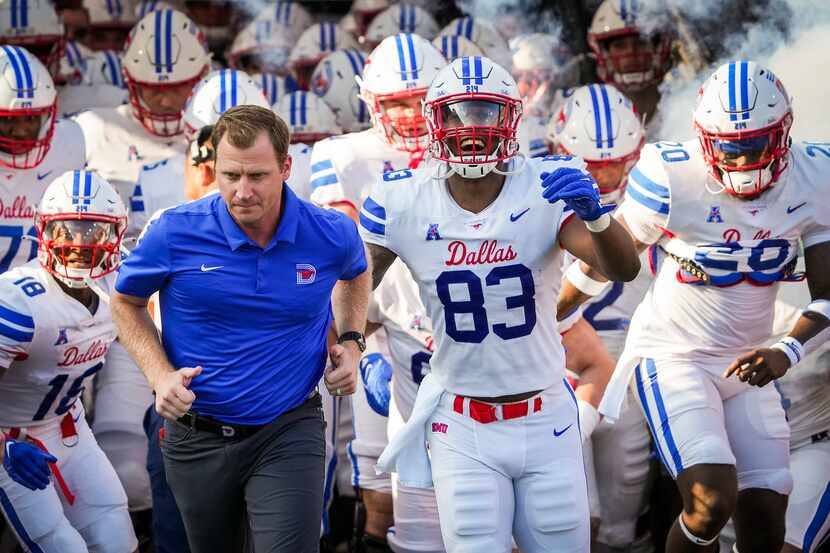 SMU head coach Rhett Lashlee leads his team as they take the field for an NCAA football game...