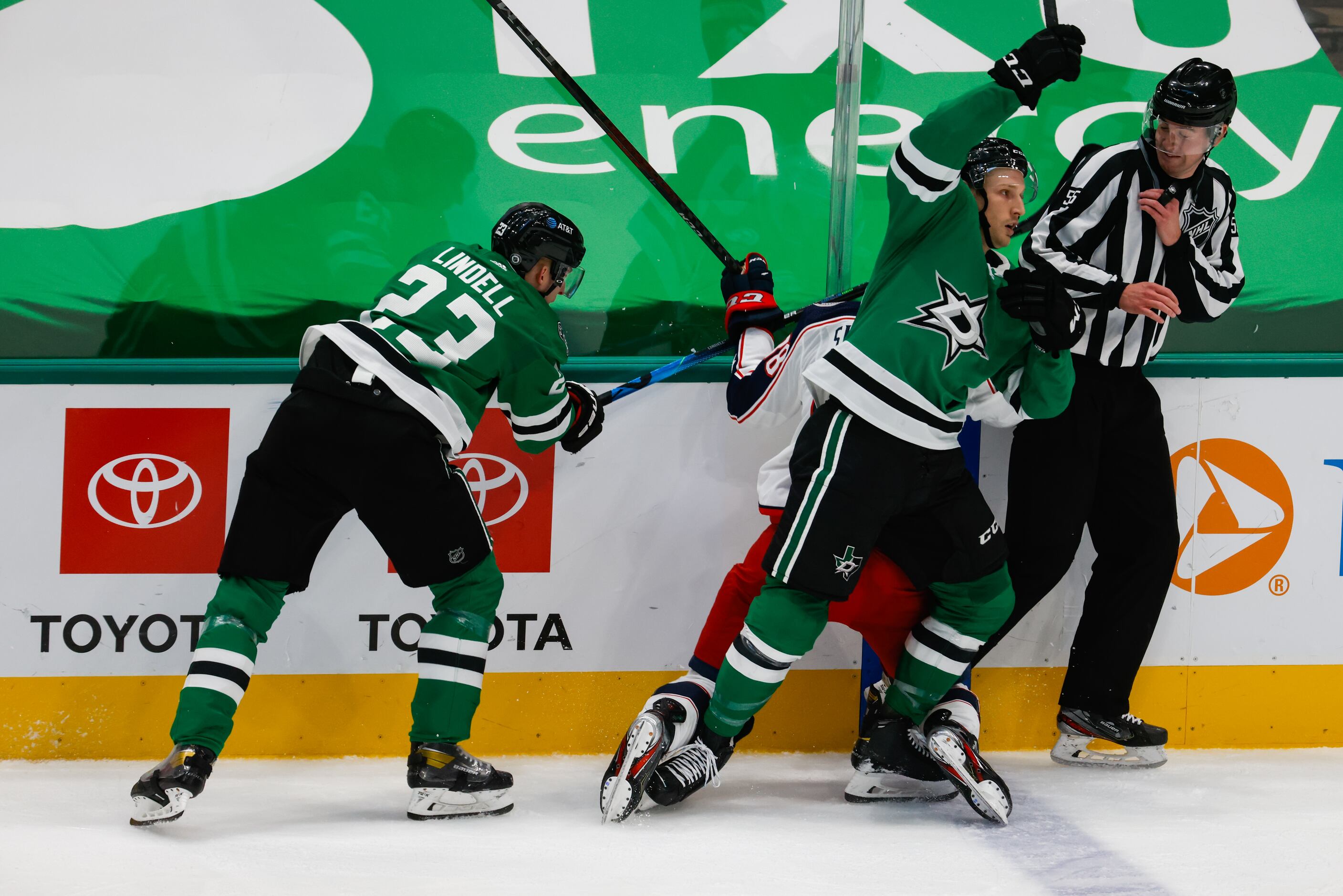 Columbus Blue Jackets and Dallas Stars players collide into Linesmen Kyle Flemington (55) in...