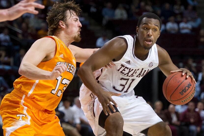 Texas A&M's Elston Turner (31) moves the ball up the court against Tennessee's Skylar McBee...