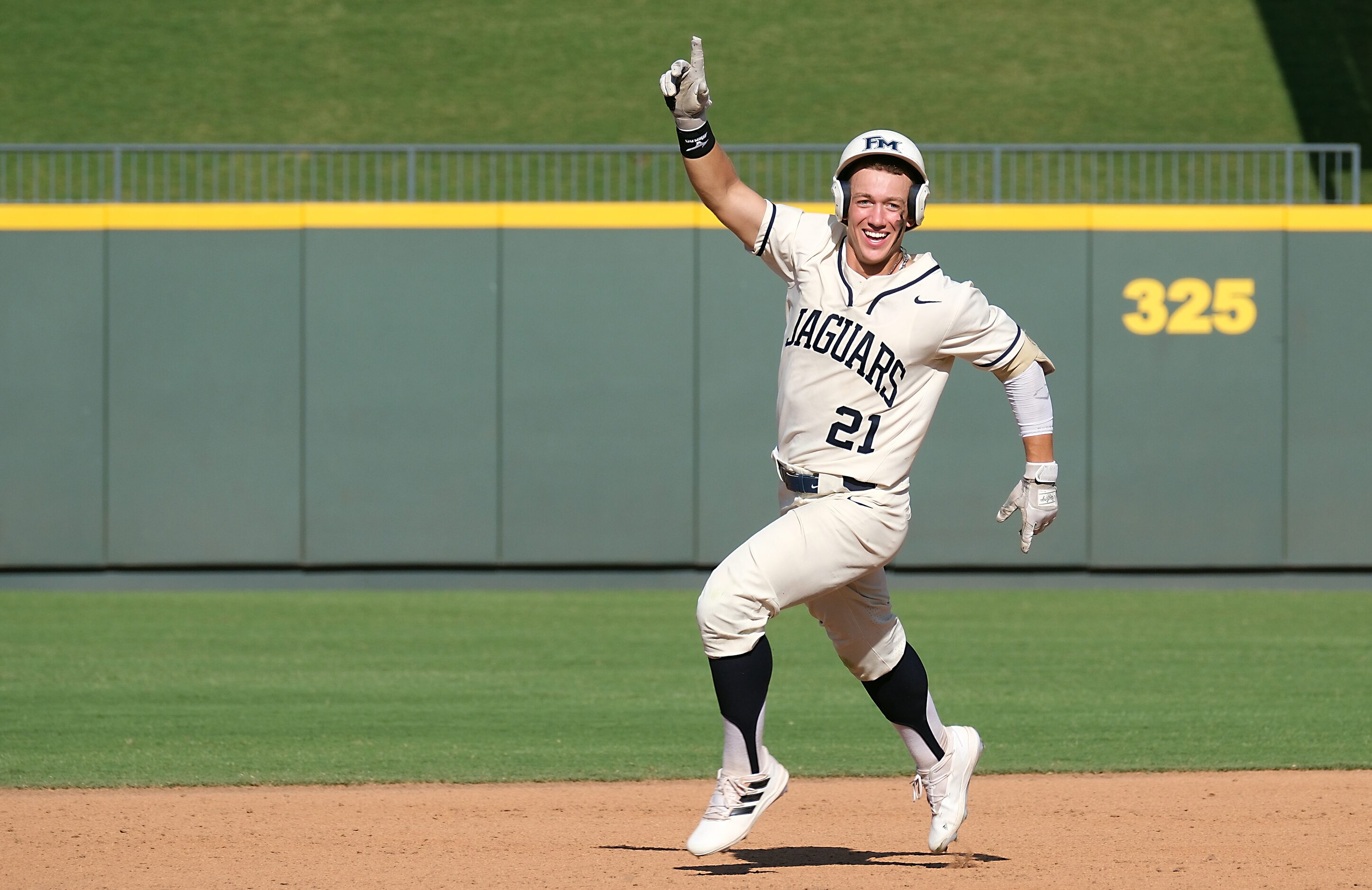 Flower Mound Sam Erickson, (21), celebrates a two-run home run against Pearland during the...