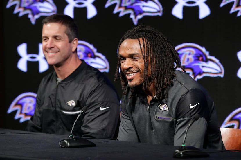 Newly-signed Baltimore Ravens NFL football cornerback Brandon Carr, right, speaks alongside...