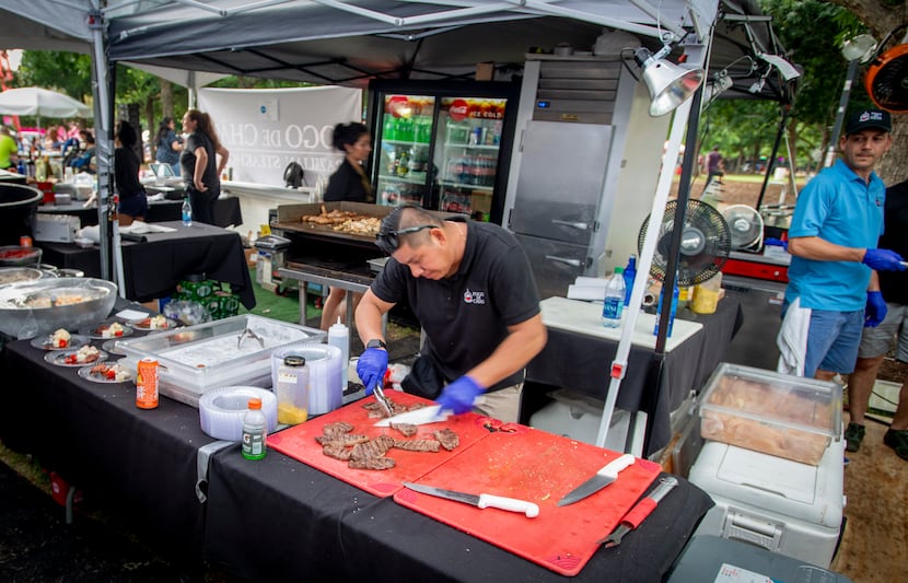 A chef from Fogo de Chao prepares food for visitors at the Taste Addison in 2019.