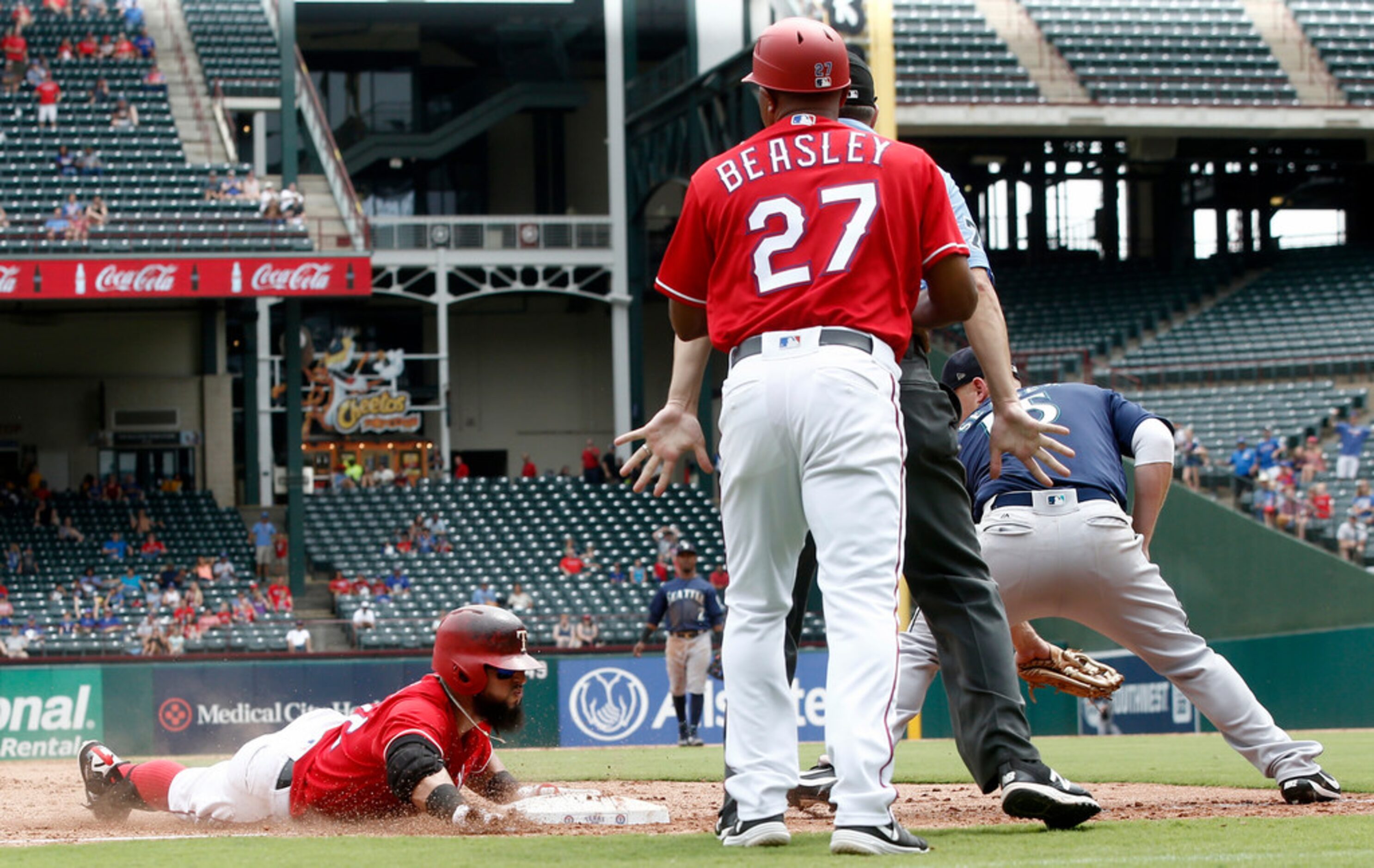 Texas Rangers Rougned Odor slides into third base for a triple as Seattle Mariners third...