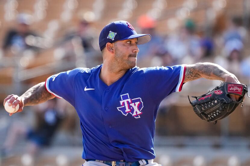 Texas Rangers pitcher Matt Bush delivers during the eighth inning of a spring training game...