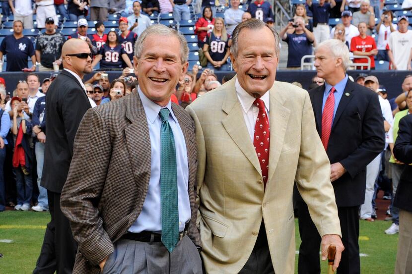 This Oct. 25, 2009 file photo shows former Presidents George H. W. Bush (right) and George...