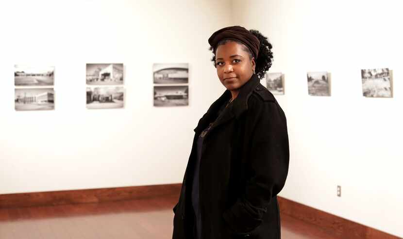 Nitashia Johnson poses for a photograph next to prints from her art show, "The Beauty of...
