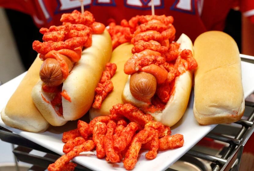 The Flamin' Hot Cheetos Dog is an all beef hot dog topped with Flamin' Hot Cheetos infused...