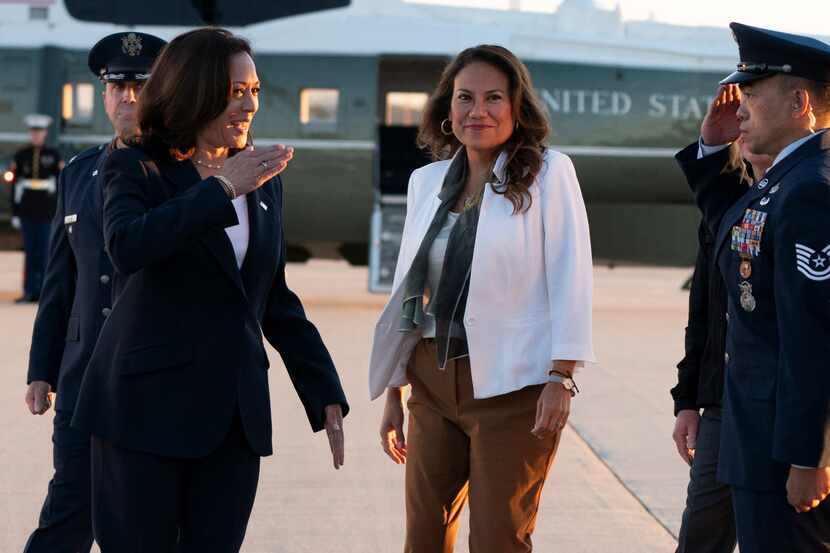 Vice President Kamala Harris, with Rep. Veronica Escobar, D-El Paso, salutes as they board...