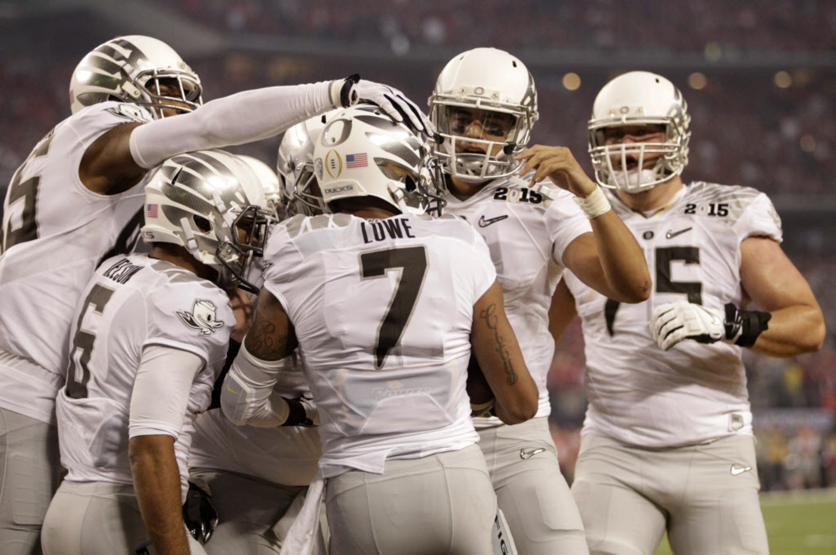 Oregon Ducks wide receiver Keanon Lowe (7) is congratulated by teammates after he scored a...