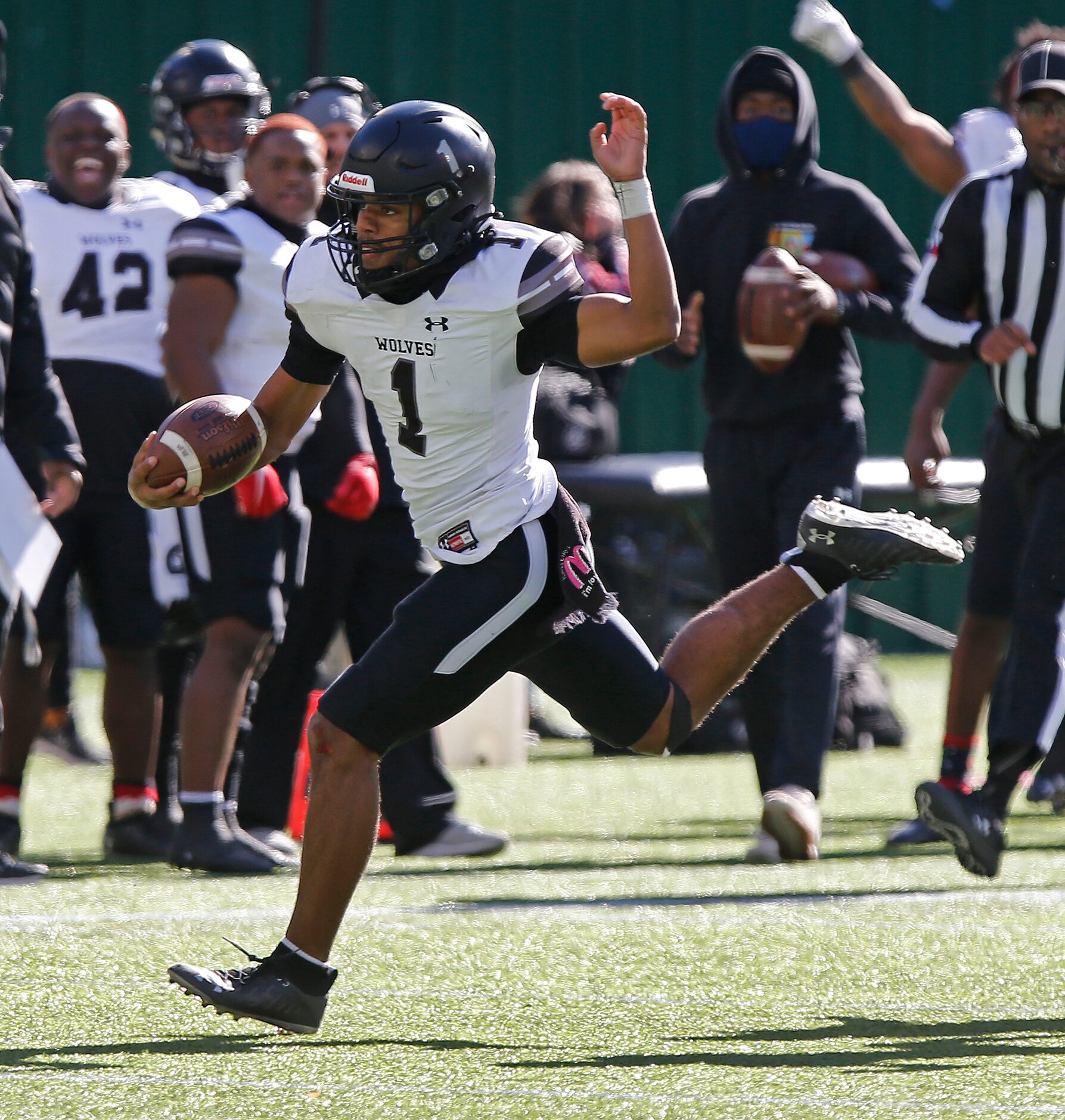 Mansfield Timberview High School quarterback Simeon Evans (1) runs for a big gain in the...