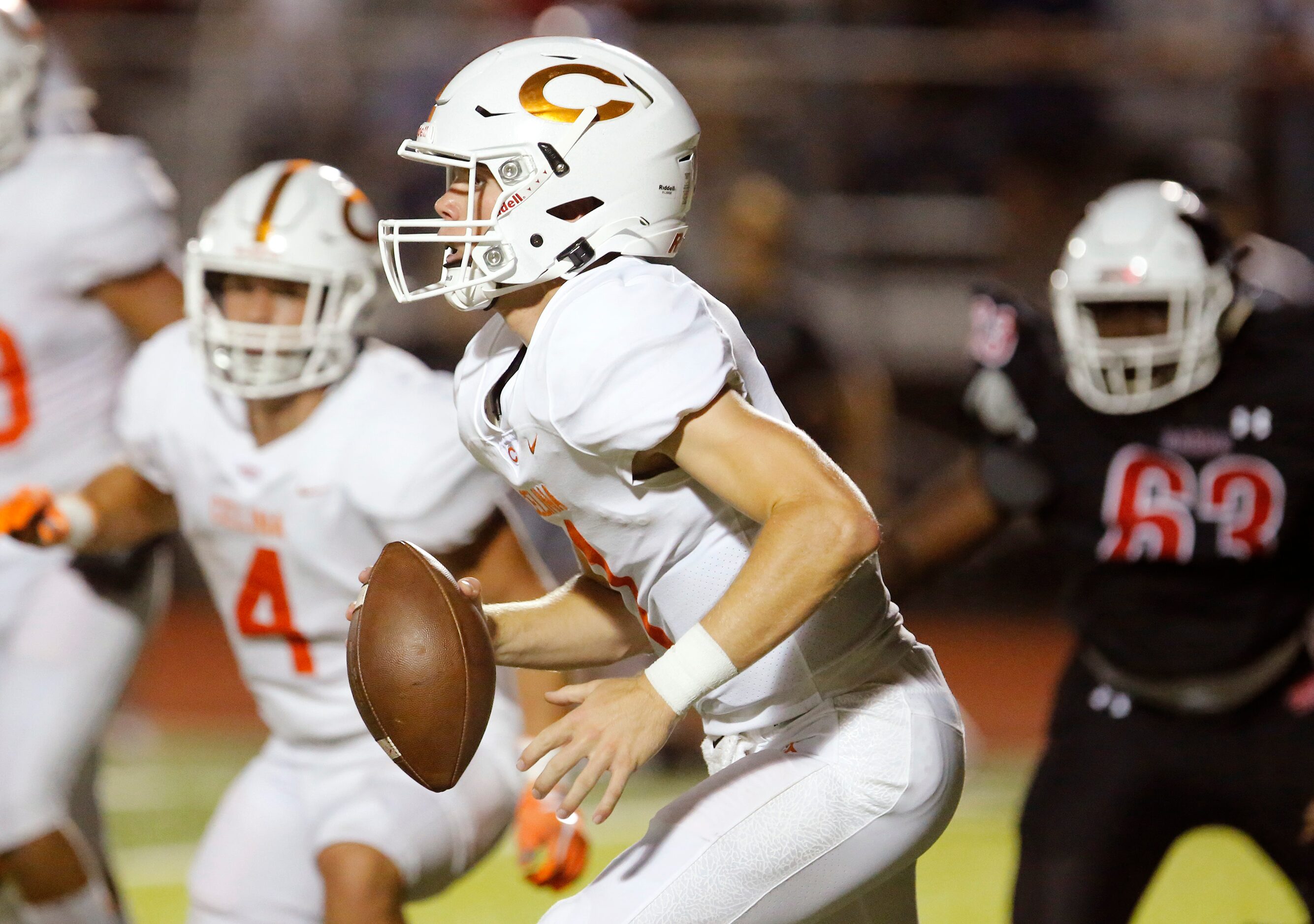 Celina High School quarterback Noah Bentley (1) scrambles during the first half as Melissa...