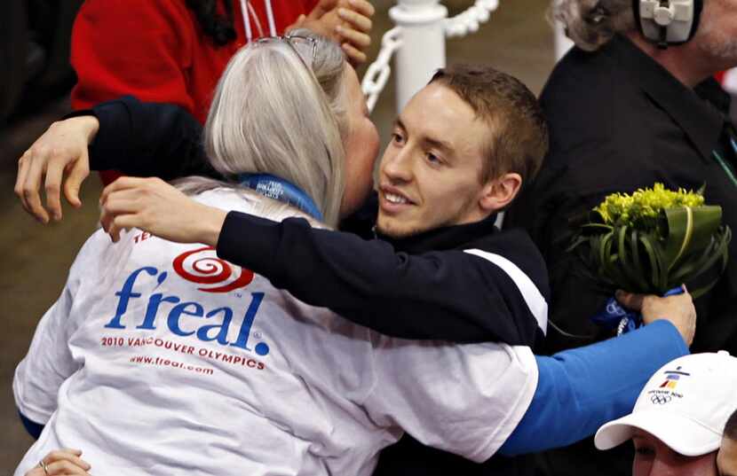 Jordan Malone (right) hugs his mother after winning a bronze medal for the men's 3000 meter...