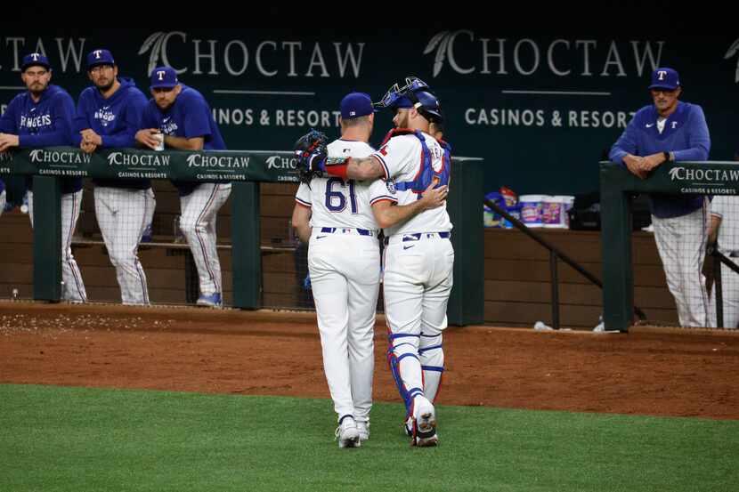 Texas Rangers pitcher Cody Bradford (61) and Texas Rangers catcher 
Jonah Heim walk together...
