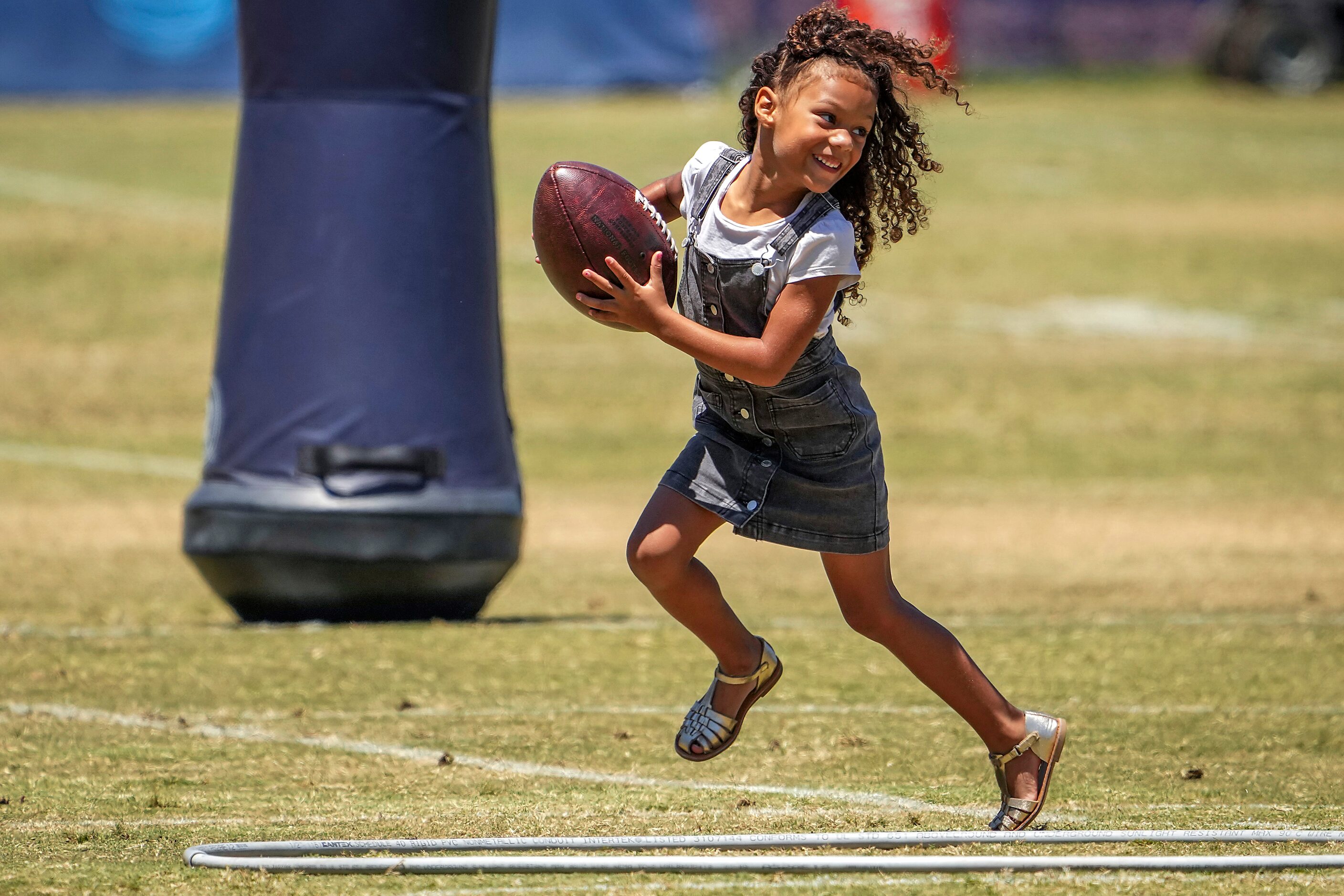 Sophia Gregory, daughter of Dallas Cowboys defensive end Randy Gregory, plays on the field...