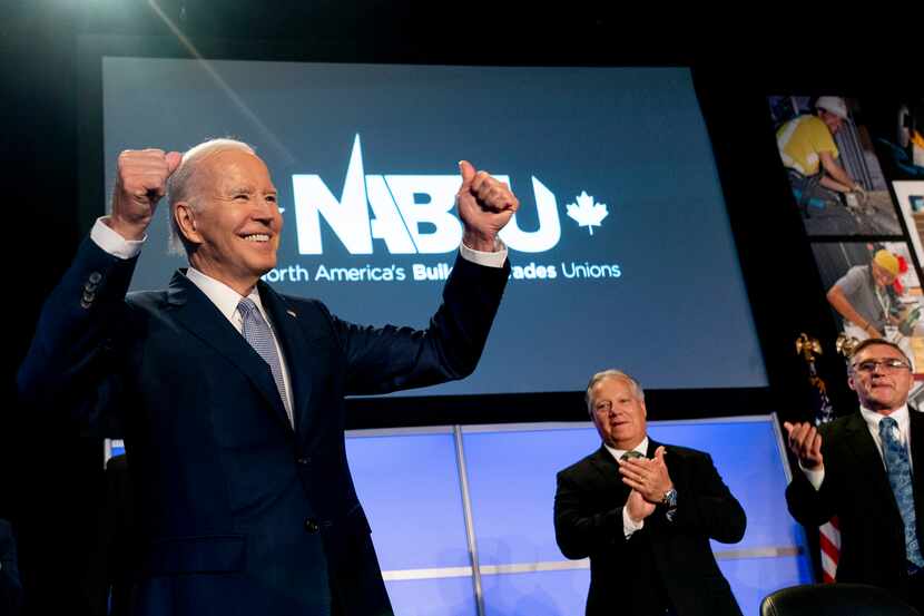 President Joe Biden pumps his fists after speaking at the North America's Building Trades...