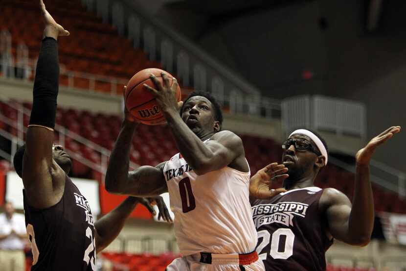 Texas Tech guard Devaugntah Williams, center, goes to the basket against Mississippi St....