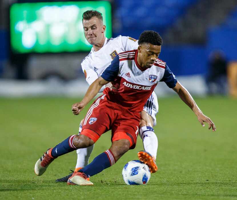 Jacori Hayes of FC Dallas is tackled form behind against Real Salt Lake on Saturday, March...