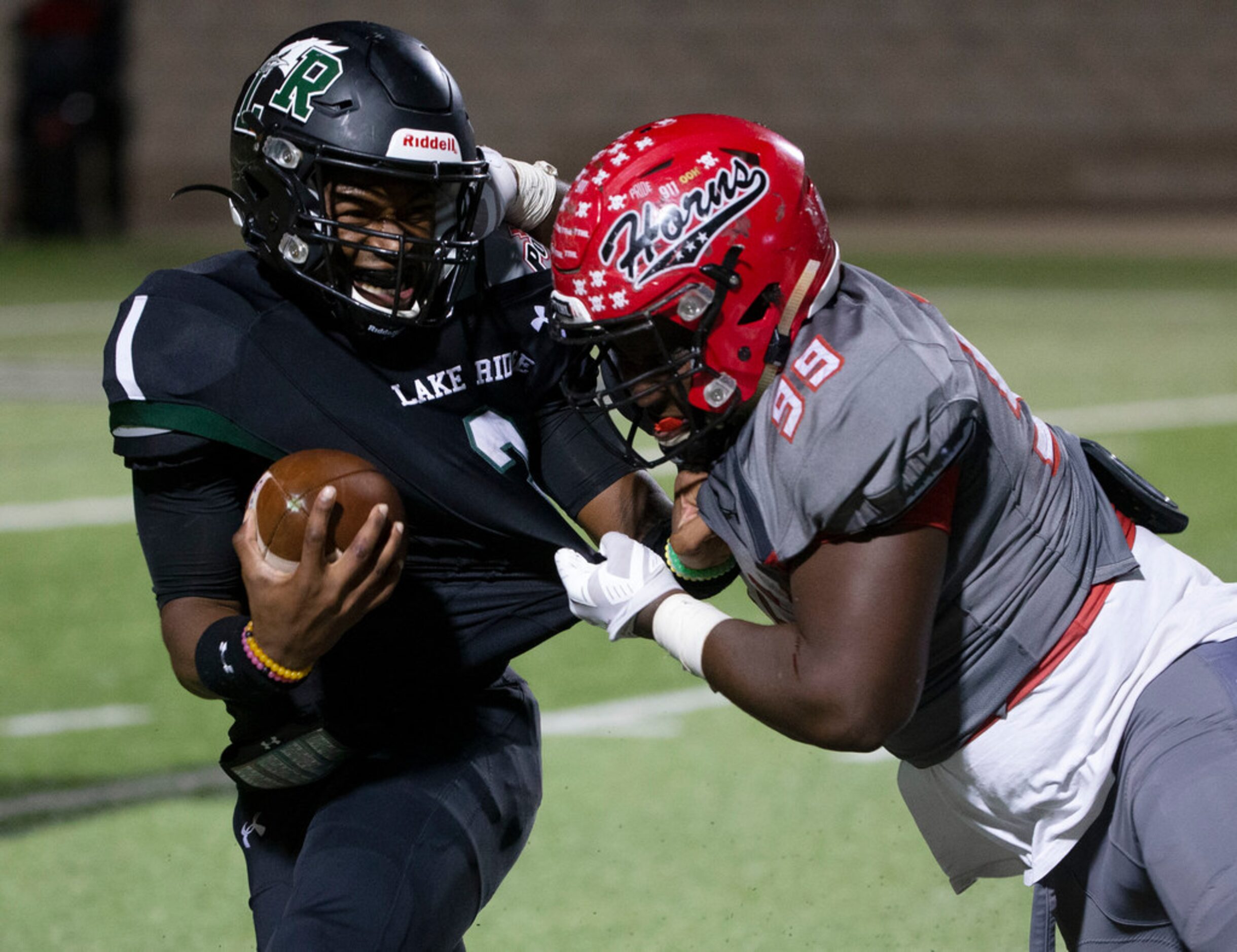 Cedar Hill's Leon Young (99) tries to tackle Mansfield Lake Ridge quarterback Adrian Hawkins...