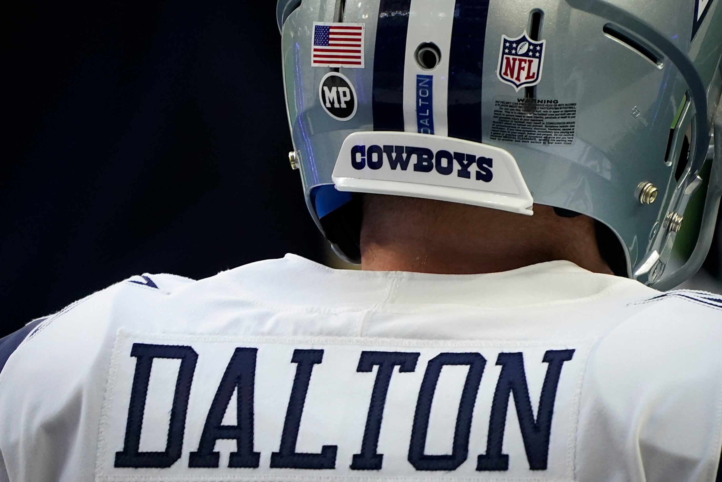 Dallas Cowboys quarterback Andy Dalton wears a sticker honoring strength and conditioning...