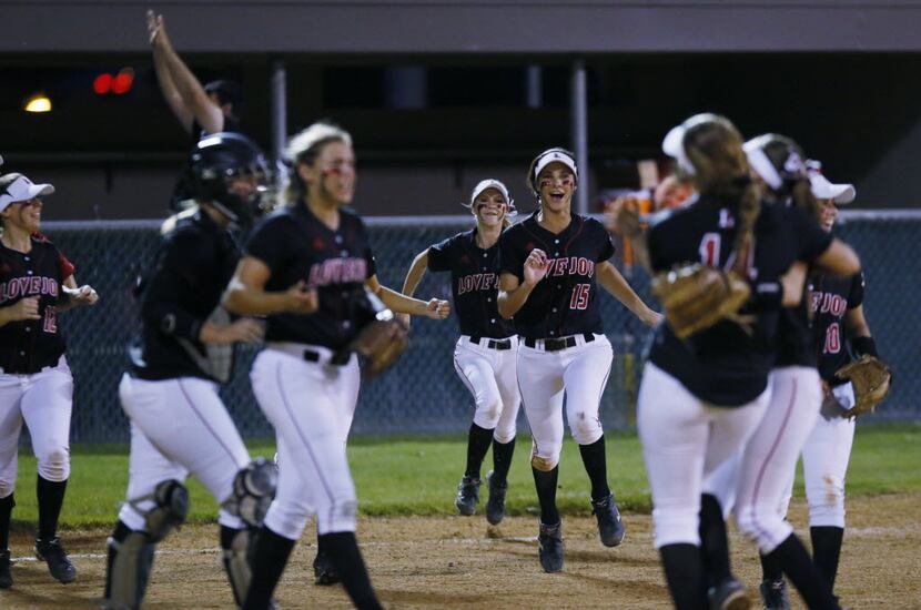 Lovejoy High School softball players celebrate their victory over Ennis High School during a...