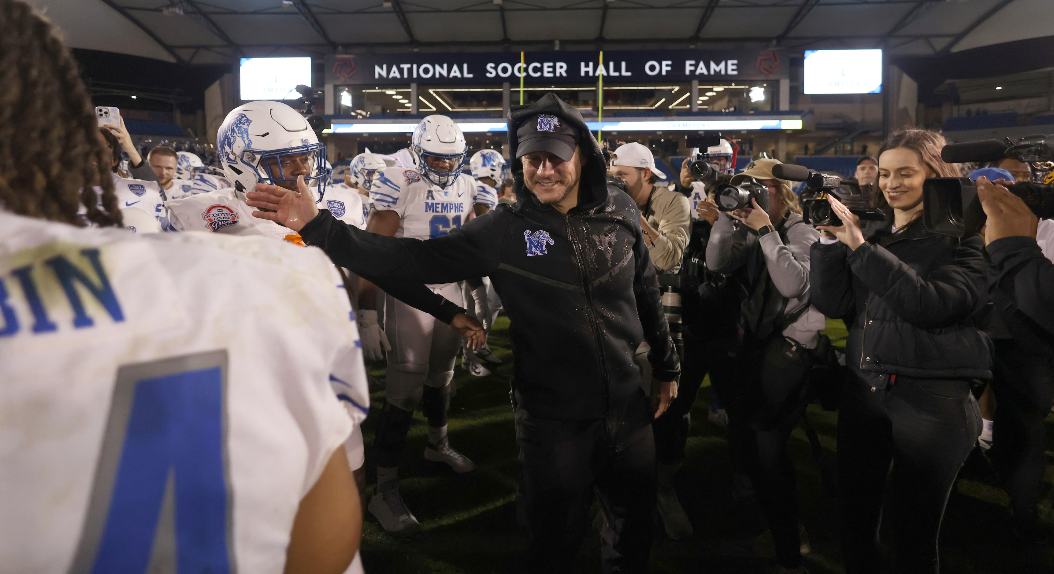 Memphis head coach Ryan Silverfield, center, was all smiles after being doused with a bucket...