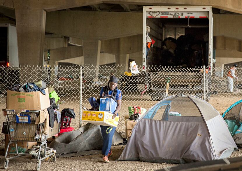 Eva James organized her belongings as crews cleaned up a homeless encampment Tuesday near...