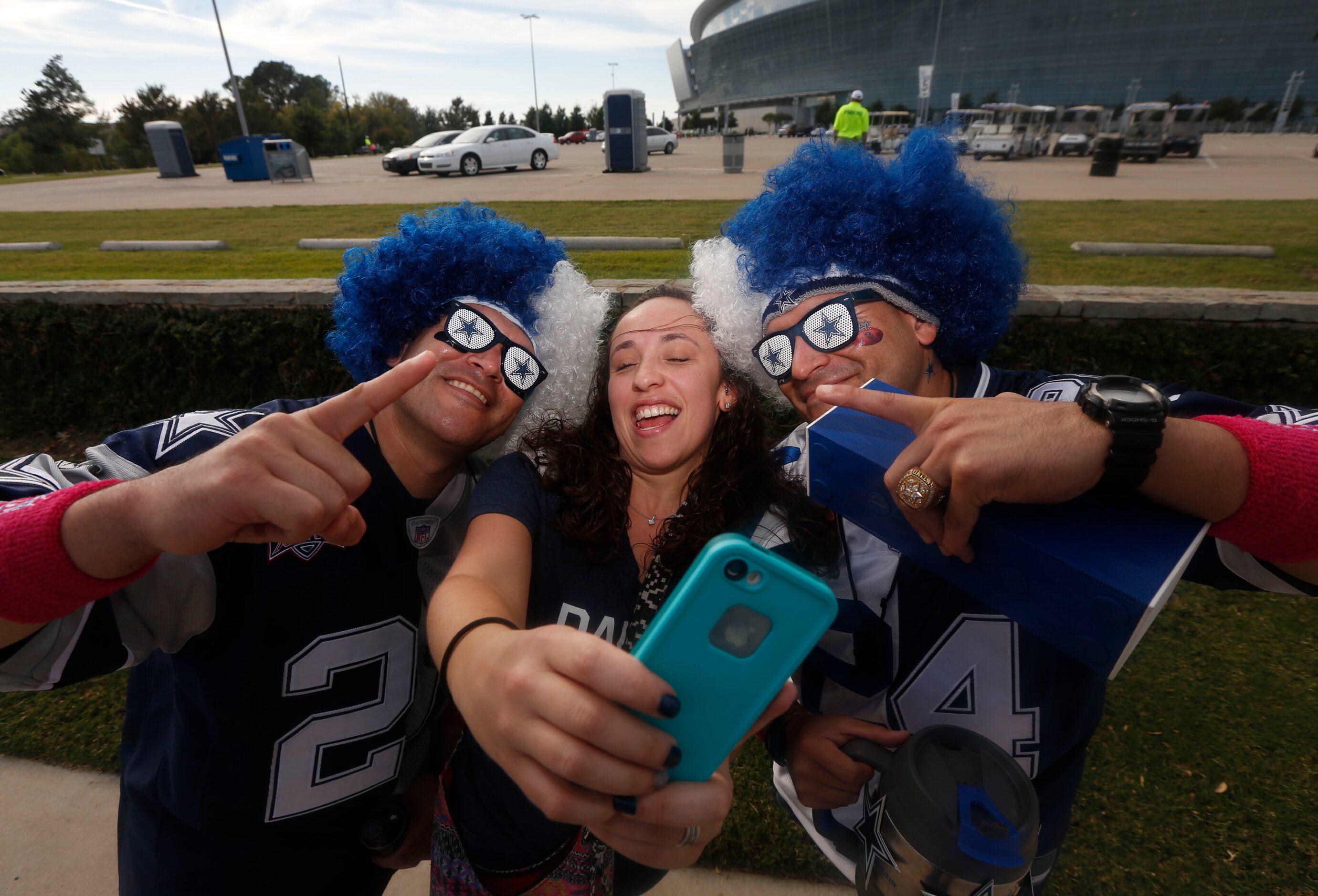 Mary O'Dell of Portland, Oregon, frames a selfie with Chris Saucedo, left, and Stephen...