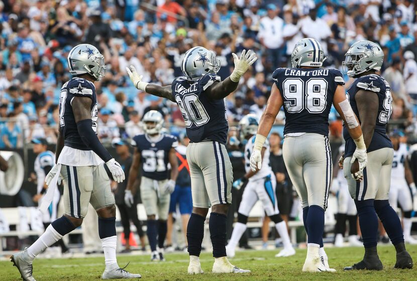 Dallas Cowboys defensive end DeMarcus Lawrence (90) celebrates his sack of Cam Newton (1)...