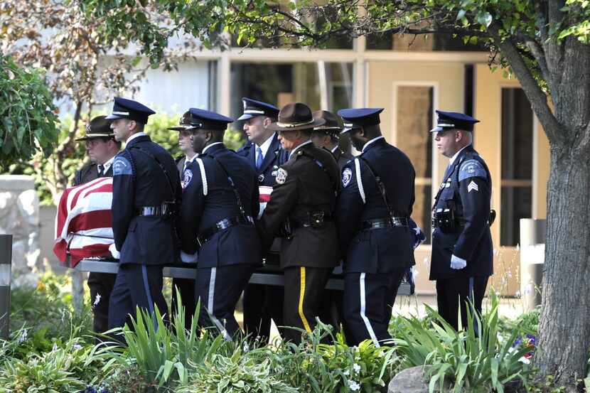Police officers carried the casket of slain Dallas police Officer Michael Krol into St....