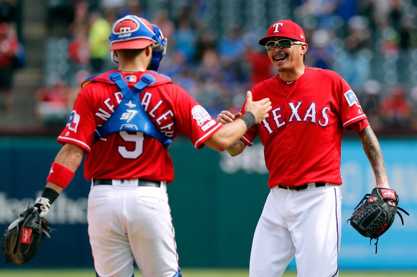 Texas Rangers' Isiah Kiner-Falefa (9) andh Jesse Chavez (53) celebrate they win against the...