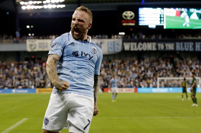 Sporting Kansas City forward Johnny Russell celebrates after scoring a goal during the...