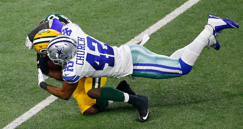 Dallas Cowboys strong safety Barry Church (42) tackles Green Bay Packers running back Ty...