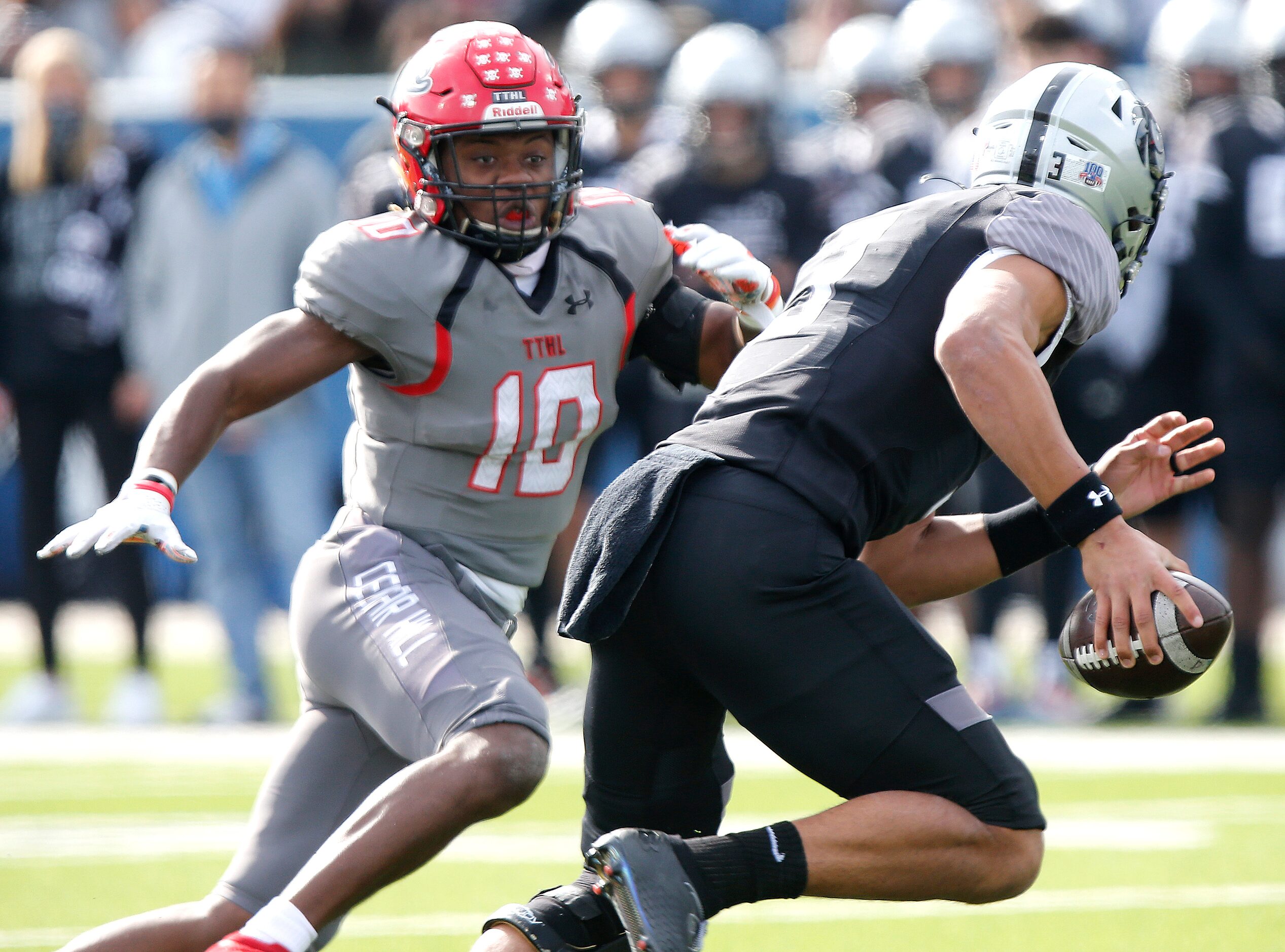 Cedar Hill High School linebacker Jaheim Lowe (10) hurries Denton Guyer High School...