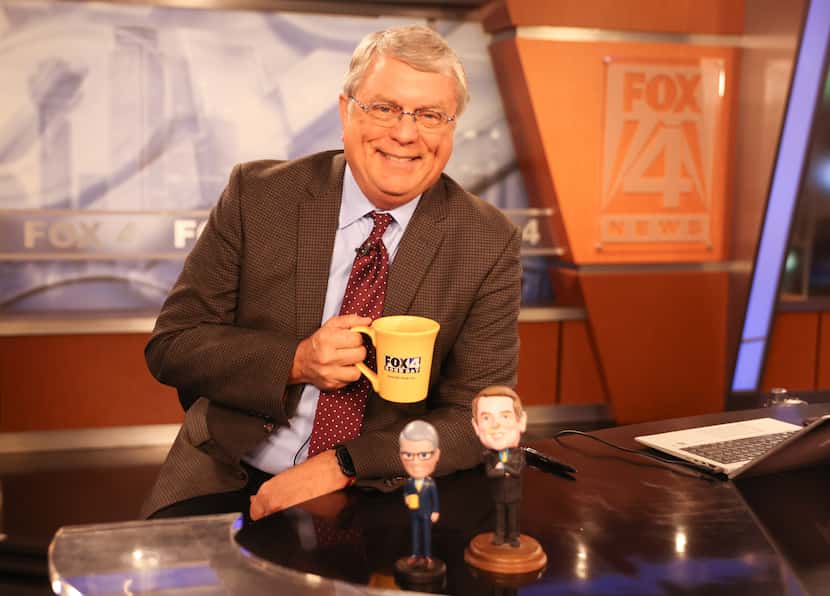 FOX 4's "Good Day" co-anchor Tim Ryan holds his yellow mug on the morning desk while two...